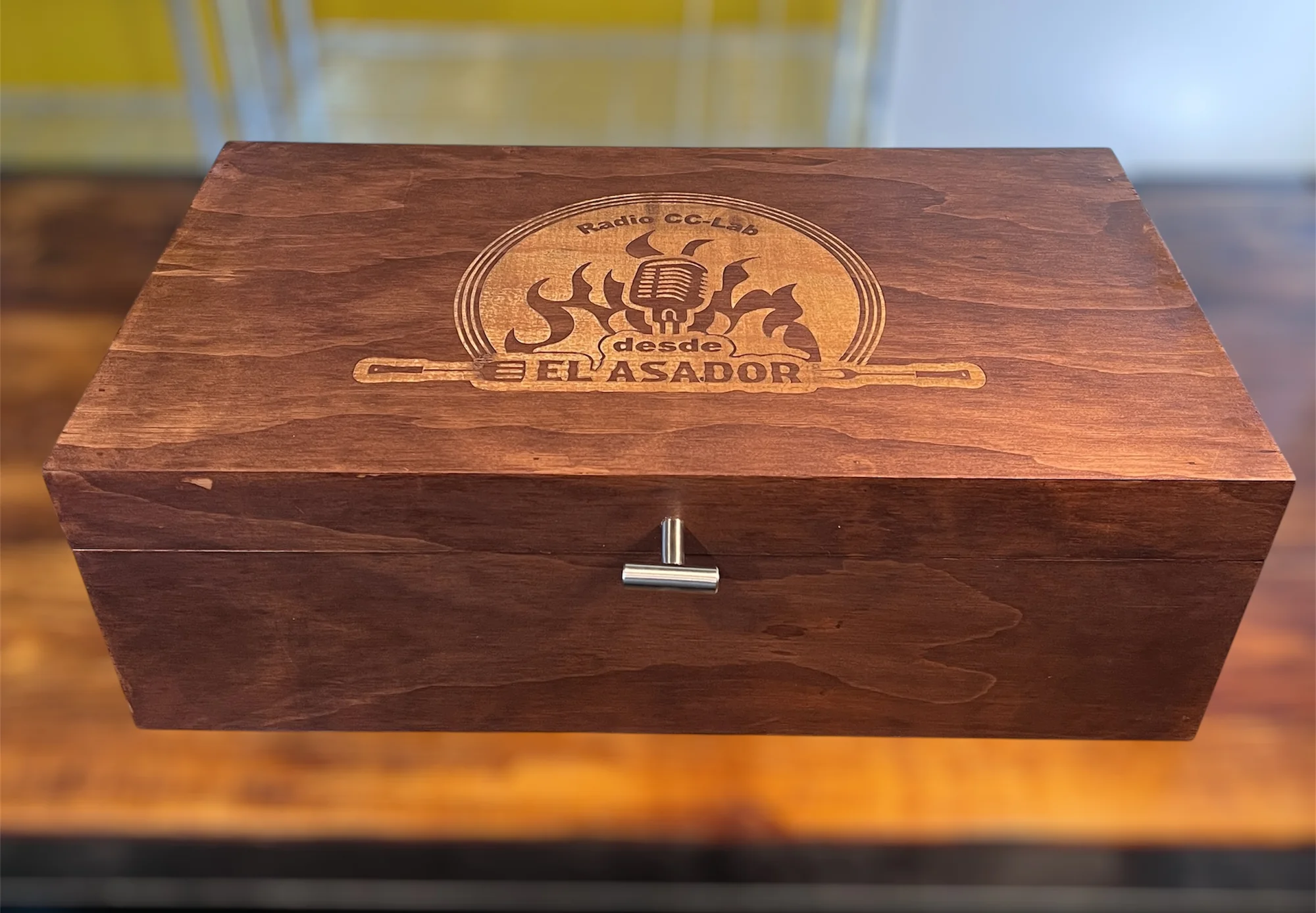 Caja de madera oscura con un grabado en la tapa que dice 